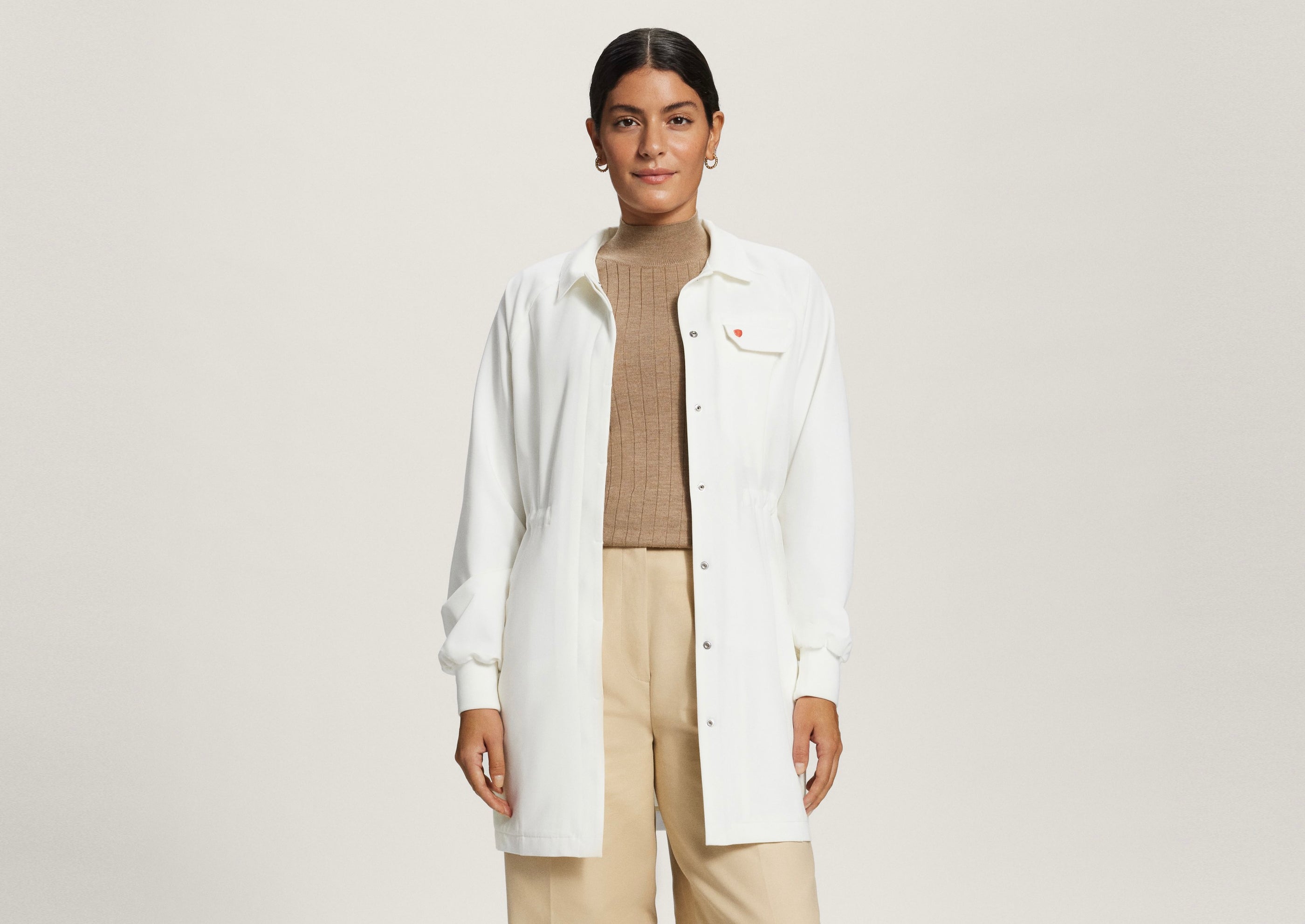 Front view of woman wearing AmorSui Lab Coat unbuttoned